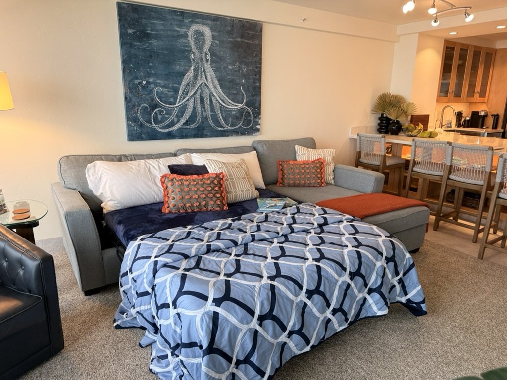 The queen sofa sleeper opened in the living room of unit 418